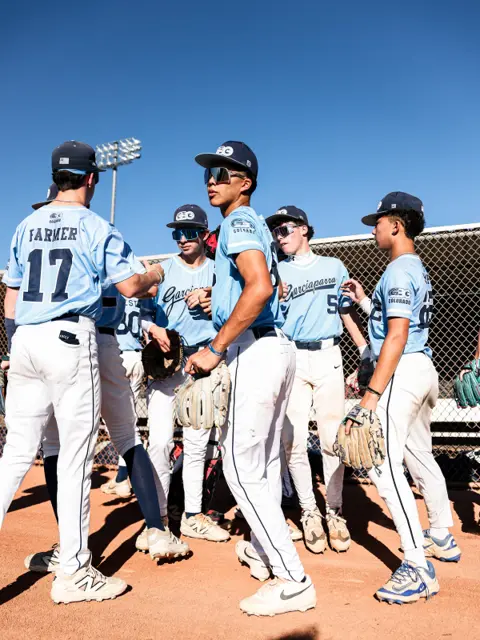 GBG Colorado 2029 players huddled on the infield