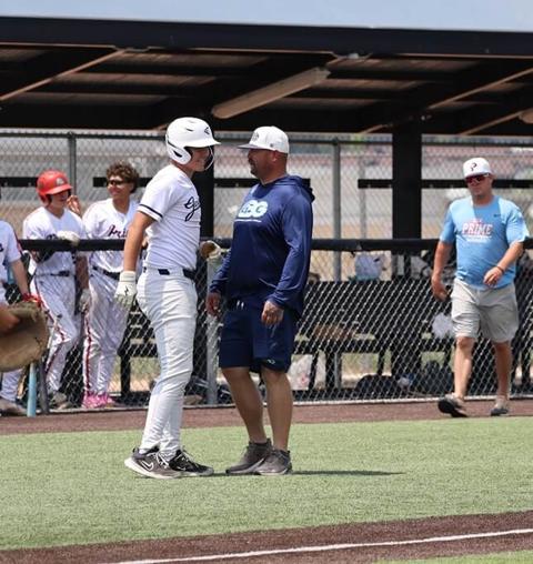 GBG Colorado player Bradley fist-bumping a coach after reaching base