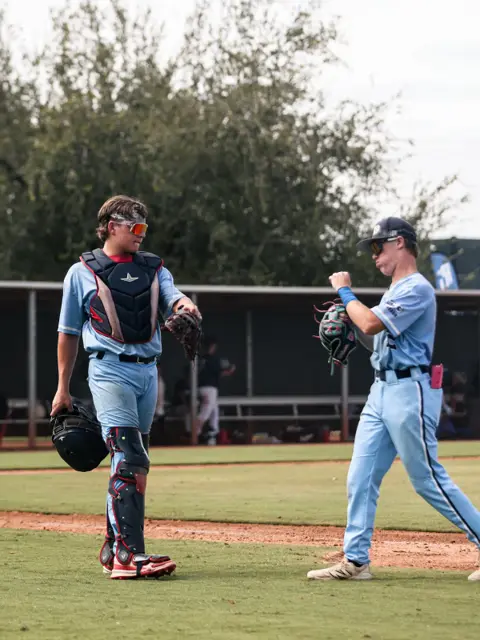 GBG Colorado catcher and batter fist-bumping on the field