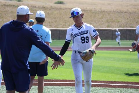 Player high-fiving a coach after a play