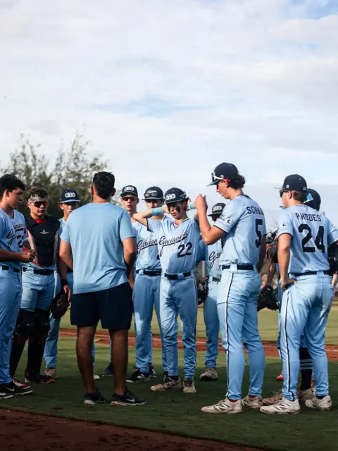 GBG Colorado coach meeting with players on the infield